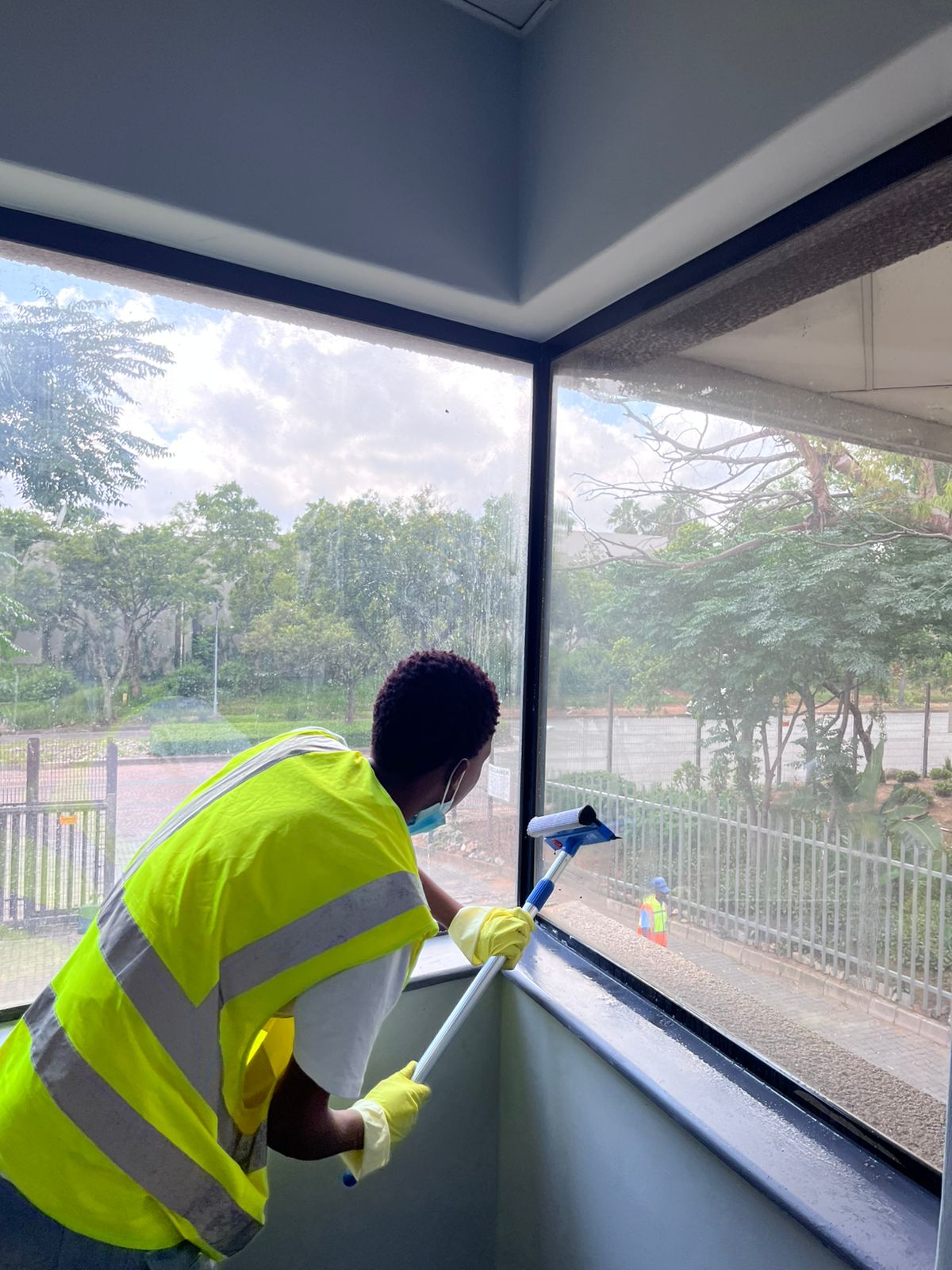 Worker cleaning an interior window